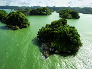 обои Скалистые островки с зеленым кустарником в море фото