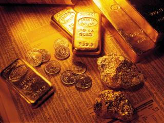 обои Золотые слитки, самородки и монеты на биржевых сводках фото