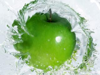 обои Сочное зелёное яблоко в брызгах воды фото