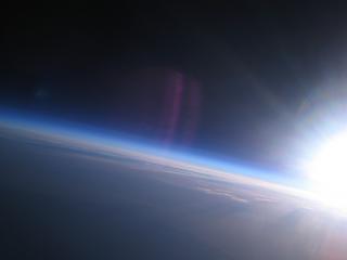 обои Солнце над атмосферой планеты фото