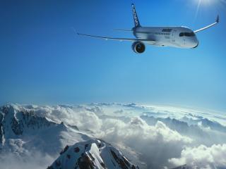 обои Самолет над острыми снежными скалами фото